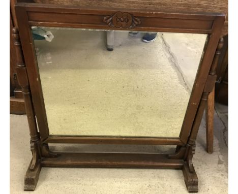 A vintage dark wood framed swing mirror with turned detail to frame.  