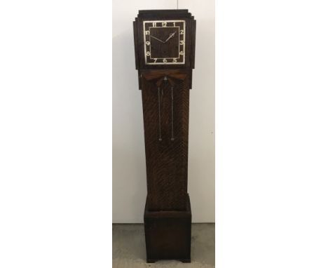 A dark wood cased Art Deco granddaughter clock. For spares or repair. Glass door missing, no key. Approx. 138cm tall.