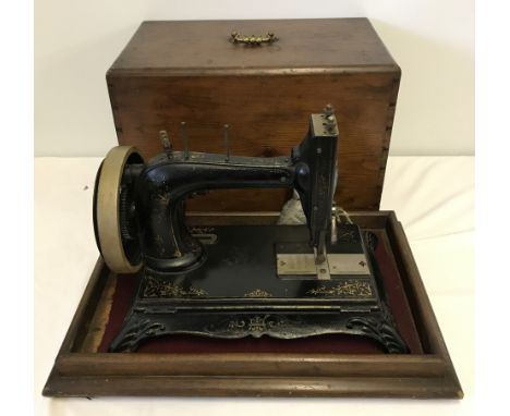 An antique German "Mothers Help, Improved" sewing machine in a custom made wooden case. Possibly by L.O.Dietrich & Co, circa 