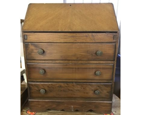 A vintage dark wood 3 drawer bureau with brown leather ling to lift down writing slope. Interior stationery compartments. Com