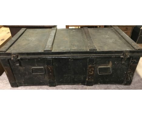A large vintage 2 handled black metal travelling chest with wooden banding.  Approx. 94cm x 48cm x 33cm tall.