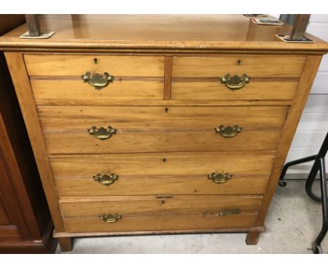 A vintage pine 2 over 3 chest of drawers. With channel detail to draw fronts and brass drop down handles. Approx. 105cm wide 