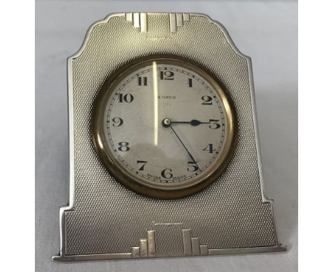 A Walker & Hall hallmarked silver clock with easel stand (a/f). Engine turned decoration to clock front. Clock face marked 8 