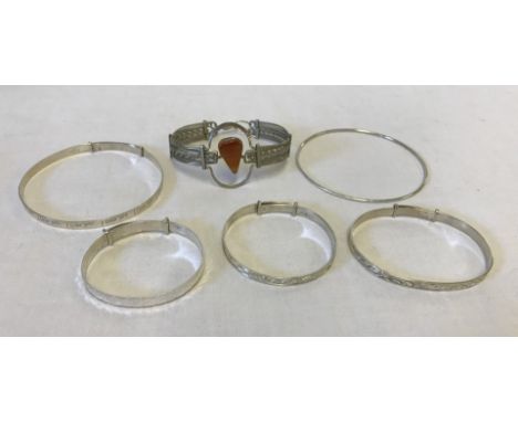 A collection of 6 silver/white metal bracelets. To include 3 children's silver expanding bangles, an adults silver expanding 