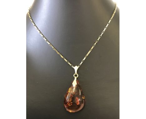 A amber drop pendant on a box link style 18 inch 9ct gold chain. Fixings to pendant not gold. chain weight 2.5g.