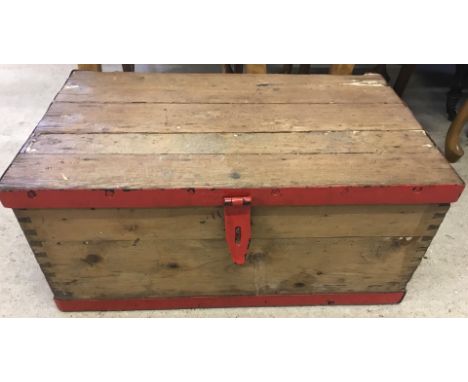 A vintage pine tool chest with red painted metal banding.  Approx. 67cm x 41cm.