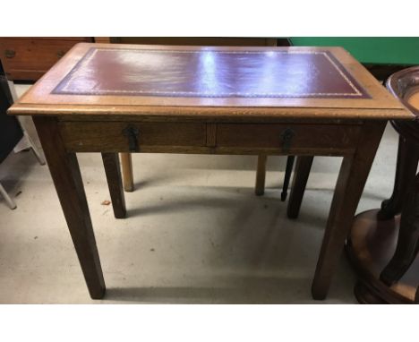 A vintage dark wood square legged 2 drawer writing desk with red leather insert to top.  Approx. 91.5cm wide x 74cm tall.