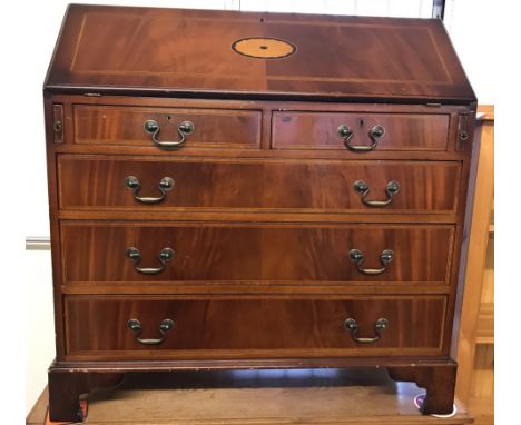 A vintage solid wood 5 drawer bureau with inlay detail. Drop down handles. With green leather insert and stationery compartme