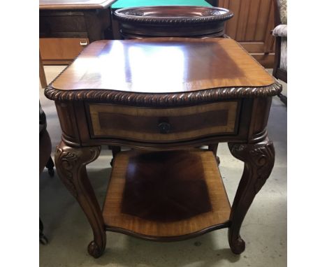 A reproduction Chippendale style occasional table with central drawer. With cabriole style legs and carved detail. Approx. 71