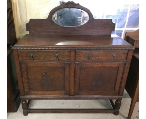 A vintage mirror backed dark wood sideboard with turned legs. Circa 1930's, 2 doors and 2 drawers, one lined with green baize