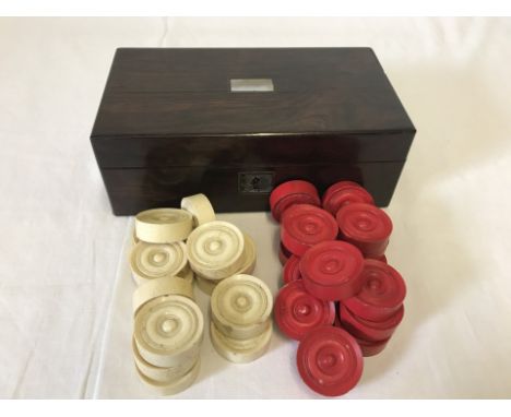 A set of vintage bone draughts pieces in a wooden lidded box. Mother of Pearl inset panel to top. Missing brass key plate. 