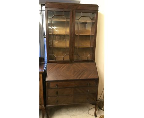 An Art deco dark wood 3 drawer bureau bookcase with feather banding veneer to front. With lift down writing slope, internal d