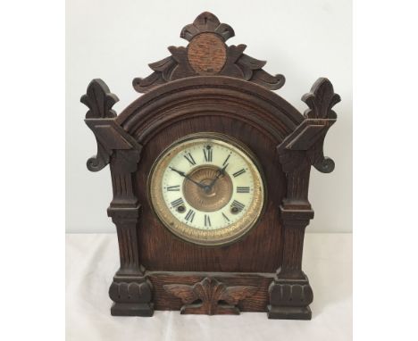A vintage wooden cased Ansonia Clock Co, New York mantel clock. Carved detail to wooden case. Complete with key and pendulum.