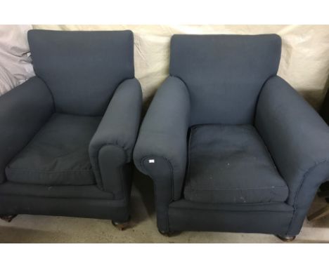 A pair of vintage armchairs with wooden bun feet and ceramic castors. Covered with petrol blue upholstery, complete with arm 