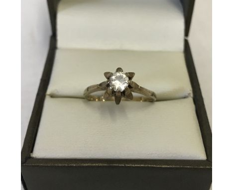 A vintage 9ct gold solitaire ring. White stone set in flower petal design mount. Size O. Approx. 2.3g. 