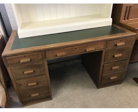 A vintage leather topped oak double pedestal desk. 3 drawers to each pedestal and 3 draws to top. Complete with keys. 137 x 6