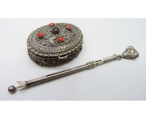A trinket box and a silver cocktail swizzler 