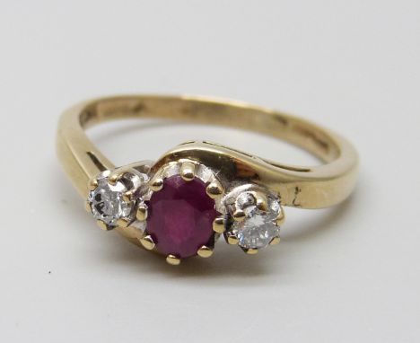 A 9ct gold, three stone ruby and diamond ring, 2.3g, M