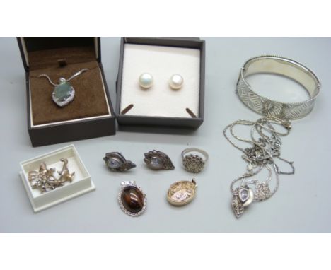 A collection of silver jewellery including a bangle, 28g, and charms