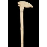 A 19TH CENTURY INDIAN IVORY CANE, the handle carved with an elephant's head and tiger's mask on a