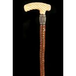 A 19TH CENTURY IVORY STAG ANTLER HANDLED CANE, the 'T' shaped grip with ripple carved decoration