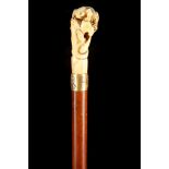 A FINE JAPANESE IVORY HANDLED CANE, the grip carved with a toad and a snake, over yellow metal