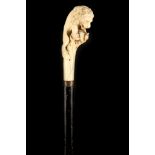 A 19TH CENTURY IVORY HANDLED EBONISED WOODEN CANE, the grip finely worked as a lion battling a
