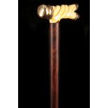 AN IVORY AND GILT METAL MOUNTED WALKING STICK, the 19th century twist carved ivory grip on a later