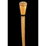 A 19TH CENTURY WHALE BONE WALKING CANE, with octagonal faceted grip and ebony collar, 90cm.