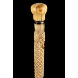 AN ANTIQUE WHALE BONE CANE, the ivory knop handle over cross hatch carving and spiral decoration