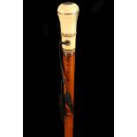 AN 18TH CENTURY IVORY AND PIQUE HANDLED CANE, the grip with inlaid decoration on a malacca shaft,