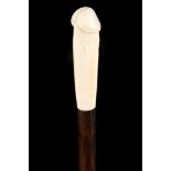 AN EROTIC WALKING STICK, the handle carved in ivory as a phallus, on a rosewood shaft, with ivory