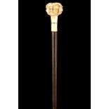 AN ANTIQUE JAPANESE NOH MASK IVORY HANDLED CANE, the grip carved with many faces, over a collar