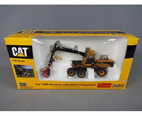 Norscot - A boxed 1:50 scale diecast Norscot #55123 Caterpillar 580B Harvester with HH65 Cutting Head. The model appears to b