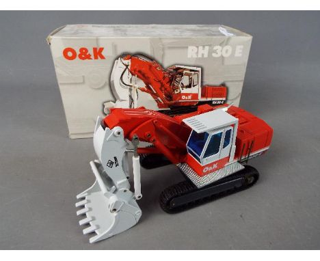 NZG - A boxed diecast 1:50 scale O&amp;K RH30E Excavator by NZG. The model appears to be in Mint condition housed in original