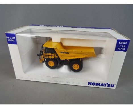 Universal Hobbies - A boxed diecast 1:50 scale Komatsu HD605 Dump Truck. The model appears to be in Mint condition in a Excel