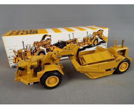 NZG - A boxed diecast 1:50 scale NZG #127 Caterpillar 627 Push-Pull Scraper. The model appears to be in Very Near Mint condit