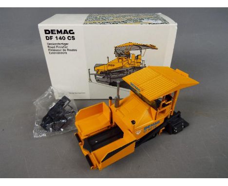 NZG - A boxed diecast 1:50 scale NZG #395 Demag DF 140 CS Road Finisher. The model appears to be in Mint condition housed in 