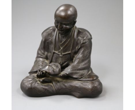 A Japanese bronze figure, holding a mask height 16cm