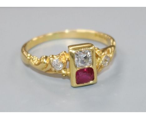 A modern 18ct gold, ruby and diamond two stone ring with diamond set shoulders, size M.