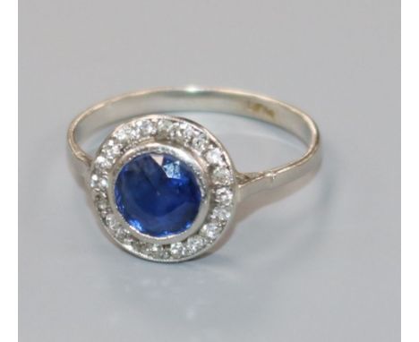 A 1920's platinum, sapphire and diamond cluster target ring, size L.