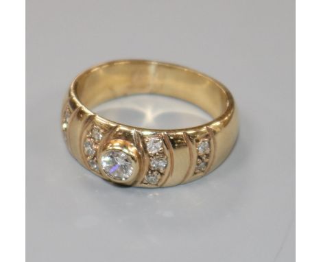 A 9ct gold and diamond set dress ring, size M.