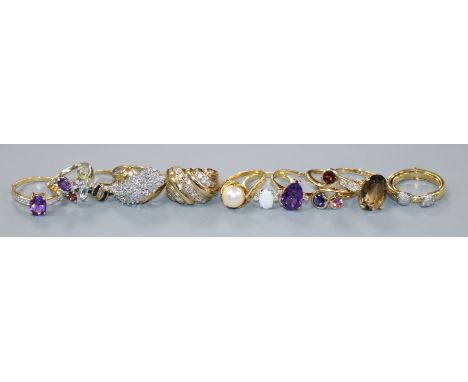 Eleven assorted 9ct gold gem set rings, including diamond, amethyst and opal, gross 39 grams.