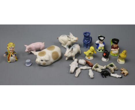 A collection of miniature dolls and ceramics and various ceramic pigs