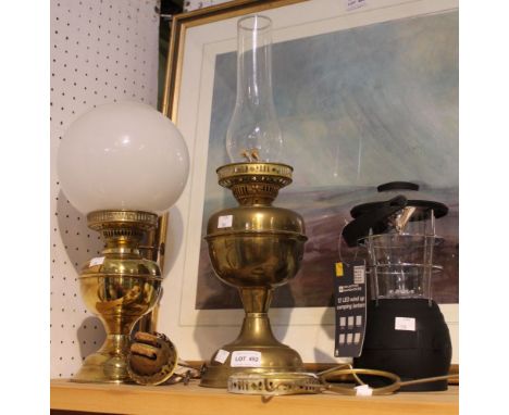 Two brass oil lamps with chimney and shade, with spare burner and some spares. Plus a modern camp lantern as new&nbsp;