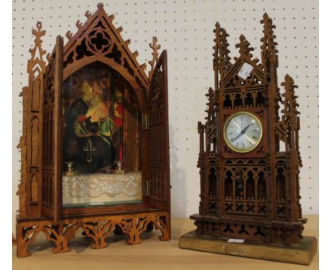 An ecclesiastical fretwork shrine with a fretwork mantel clock in similar style