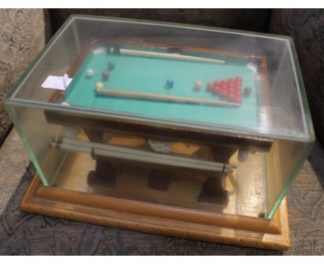 A miniature presentation snooker table in case, very well made to include balls, cues and rests