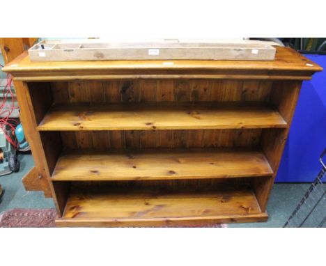 A long low modern pine three shelf open bookcase