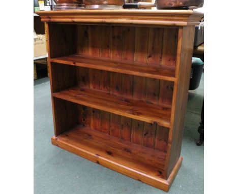 A modern pine three shelf open fronted bookcase