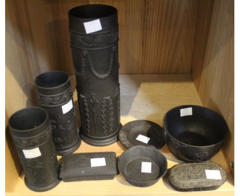 A collection of Wedgwood black basalt wares, includes three taper holders, the tallest 24cm high, two lidded boxes, two bowls